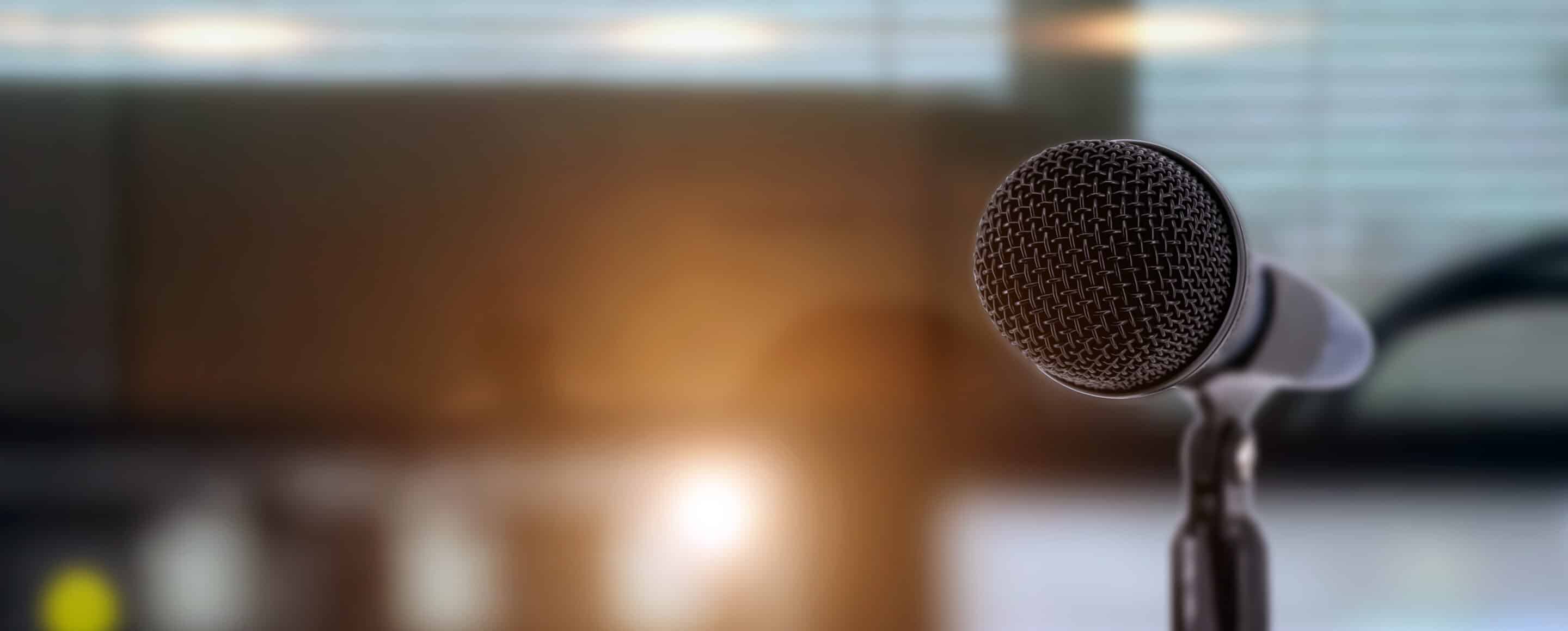 A dynamic microphone with lighting behind for music news.